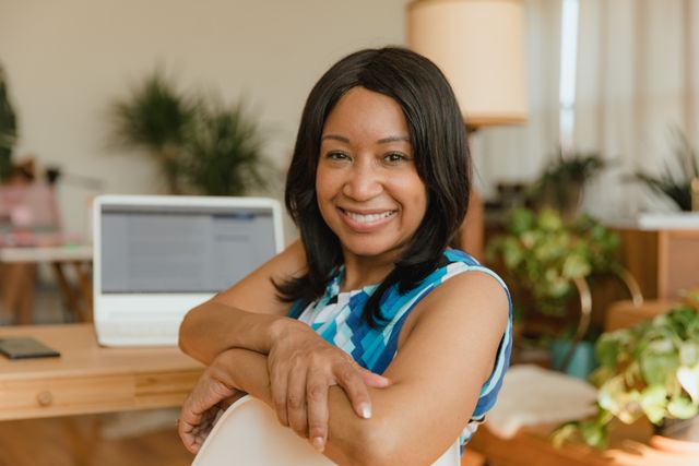 Confident female small business owner at her desk smiling during a mid-year business bankability review