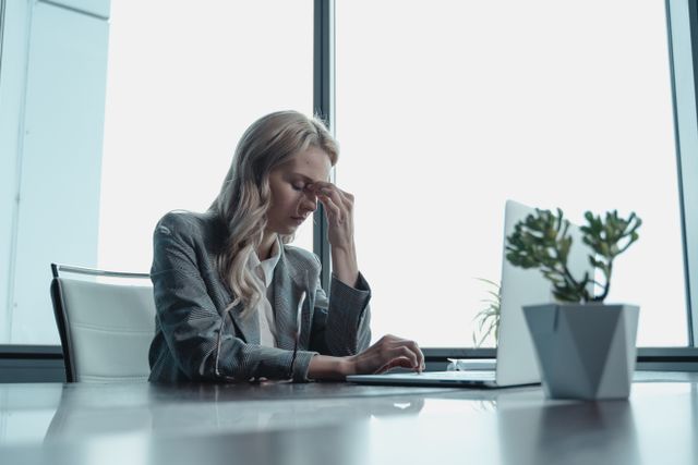 Stressed small business owner at desk with laptop reflecting margin pressure facing firms under $500K in 2026