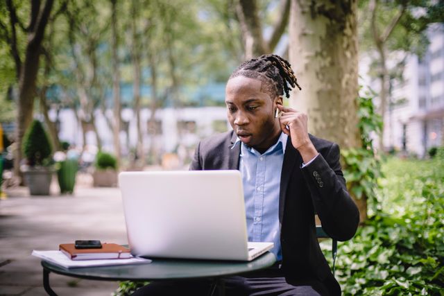 Business leader working casually with a laptop and phone, representing personal AI adoption
